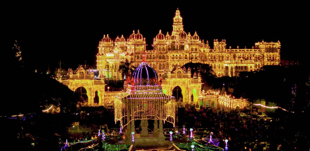 Mysore Dussehra: Aerial night view of Mysore city with the palace and streets glowing with thousands of festive lights during Dussehra celebrations.